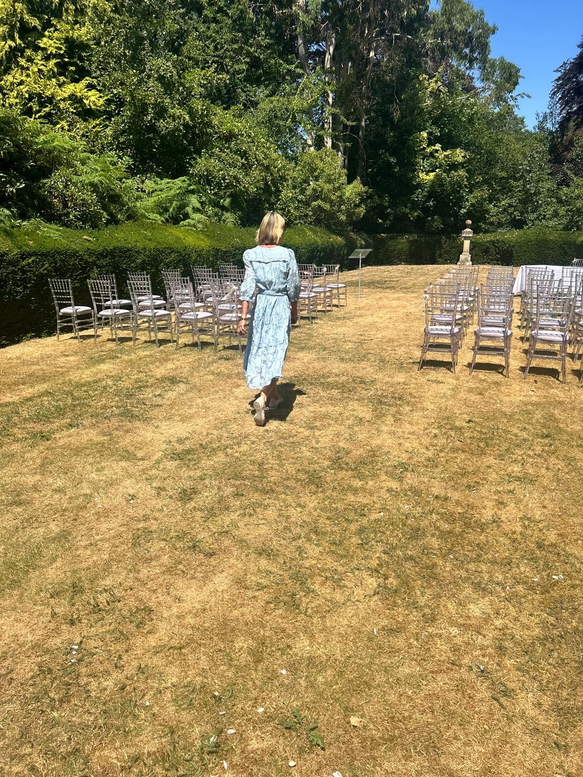 Jane walking down the aisle at a garden ceremony