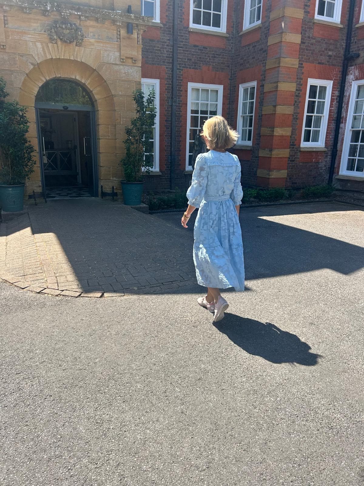 Jane walking towards the venue entrance